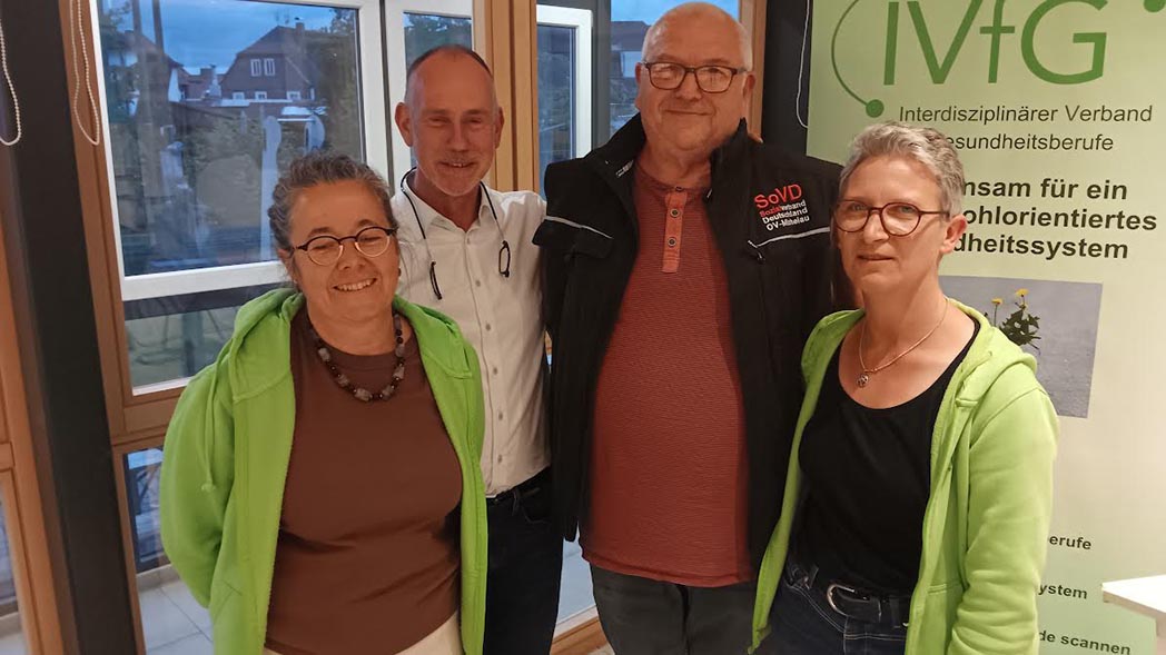 Zwei Männer eingerahmt von zwei Frauen.